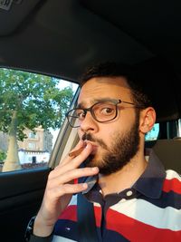 Portrait of young man in car