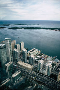 High angle view of buildings by sea against sky