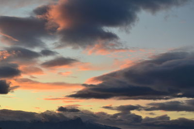 Scenic view of mountains against cloudy sky