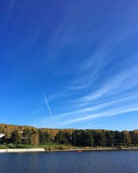 Scenic view of lake against blue sky