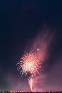 Low angle view of firework display at night