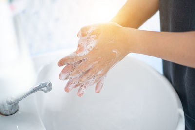 Midsection of woman in bathroom at home