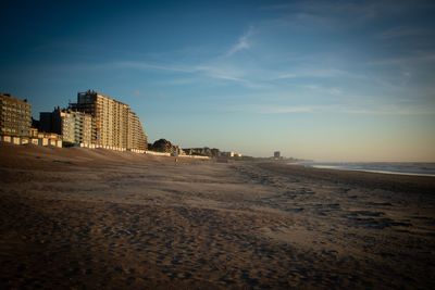 Scenic view of beach against sky in city