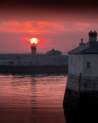 Lighthouse at seaside during sunset