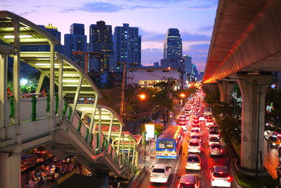 High angle view of illuminated street amidst buildings in city