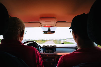 Rear view of man driving car