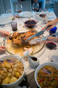 Family thanksgiving table with turkey, gravy and side dishes. november