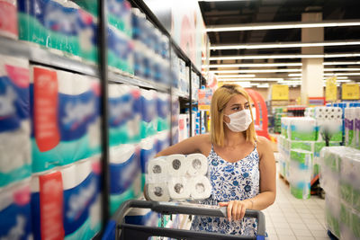 Woman wearing mask shopping at mall