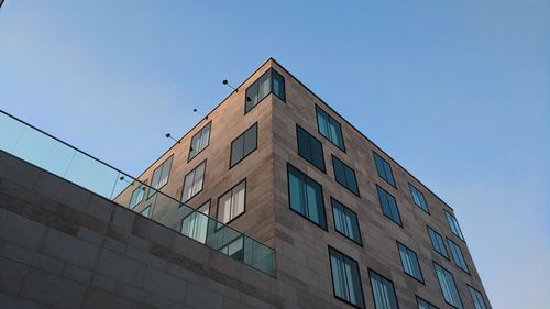 Low angle view of building against clear blue sky