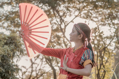 Young woman holding umbrella