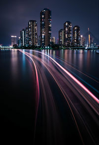 Light trails in illuminated city at night