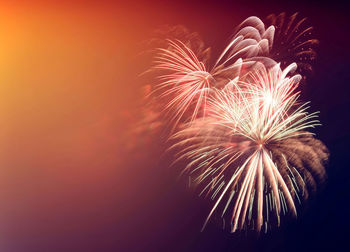 Low angle view of firework display at night