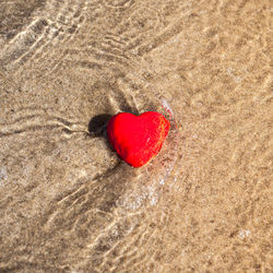 Close-up of heart shape on sand