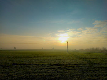 Scenic view of field against sky during sunset