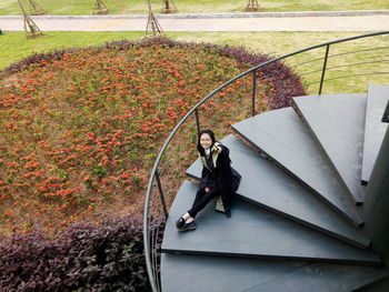 High angle view of woman on steps in park