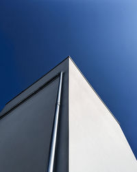 Low angle view of building against clear blue sky