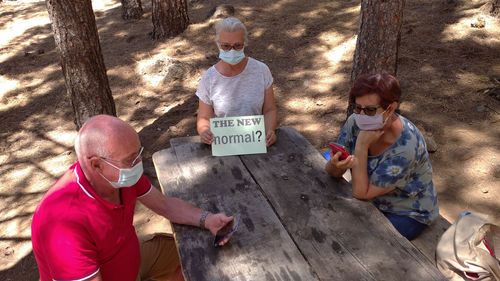 Rear view of people sitting outdoors