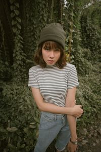Full length of girl wearing hat standing in forest