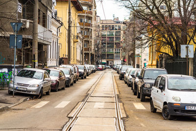 Traffic on road amidst buildings in city