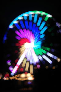 Low angle view of illuminated ferris wheel