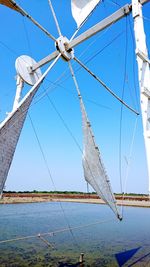 Low angle view of sailboat against blue sky