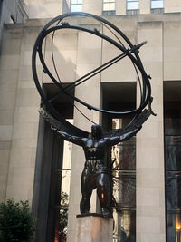 Low angle view of statue against building