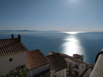 Panoramic view of buildings by sea against sky