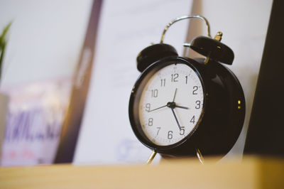 Close-up of alarm clock on table