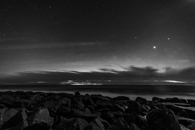 Scenic view of sea against sky at night