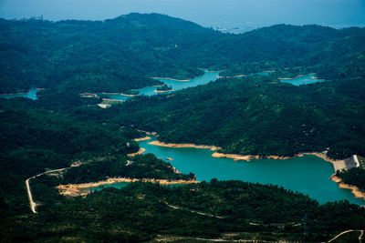 High angle view of lake and trees against sky