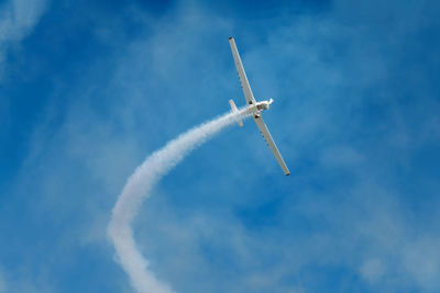 Low angle view of airplane flying against sky