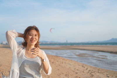 Portrait of smiling young woman on beach