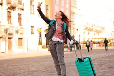 Girl travels around the city with luggage