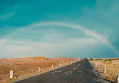 Empty road along countryside landscape