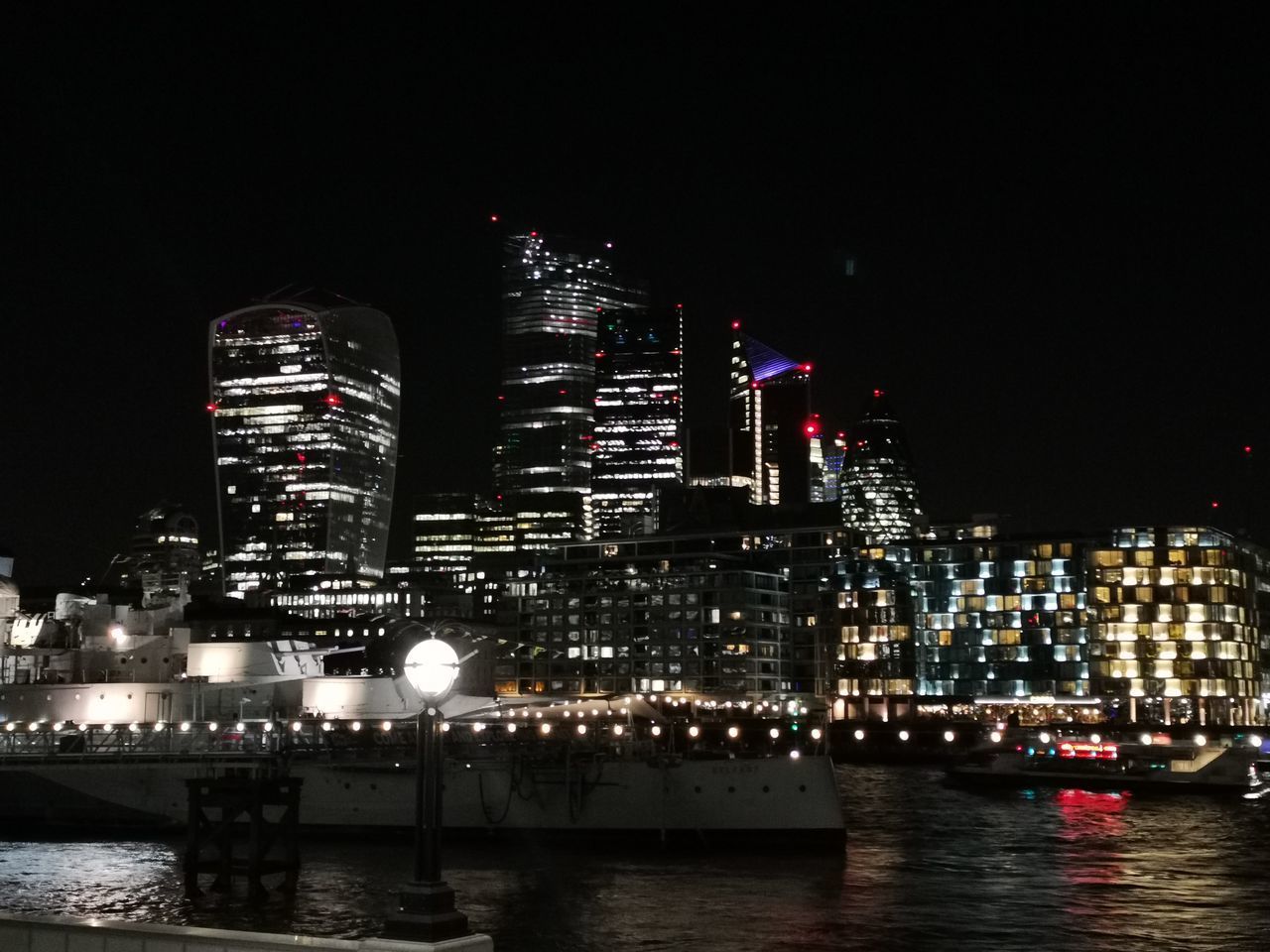 ILLUMINATED BUILDINGS IN CITY AT NIGHT