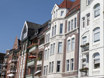 Low angle view of buildings in town against sky