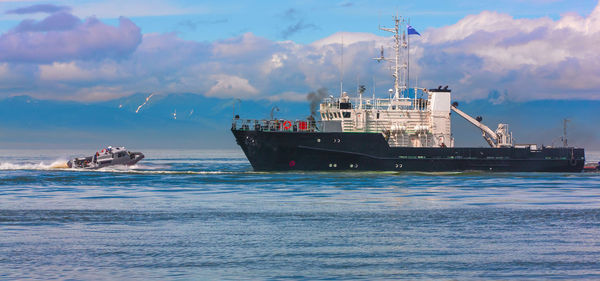 Ship sailing on sea against sky