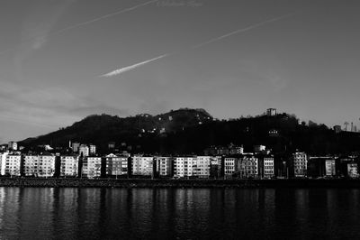Scenic view of sea by buildings against sky
