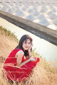 Portrait of woman sitting on field