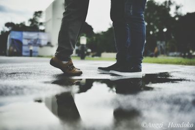 Low section of man walking on footpath