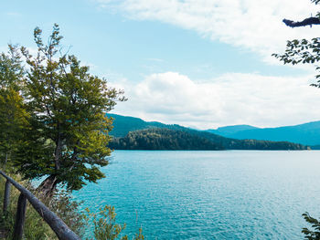 Scenic view of lake and mountains against sky