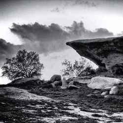 Scenic view of rock formation against cloudy sky