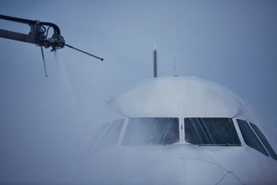 Winter frosty day at airport. deicing of airplane before flight.