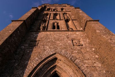 Low angle view of built structure against blue sky