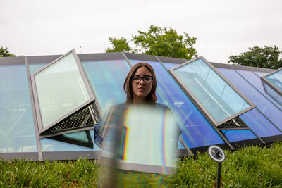 Woman standing on field against sky