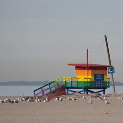 Lifeguard hut on beach against sky