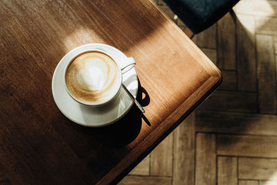 Cup of latte on the table top view. breakfast at the cafe