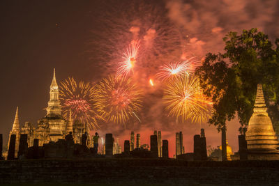 Firework display over city at night