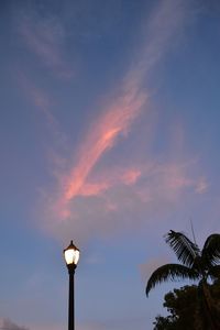 Low angle view of street light against cloudy sky