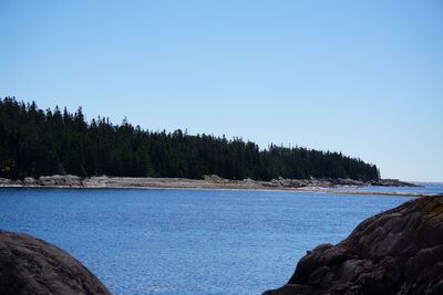 View of calm sea against clear blue sky